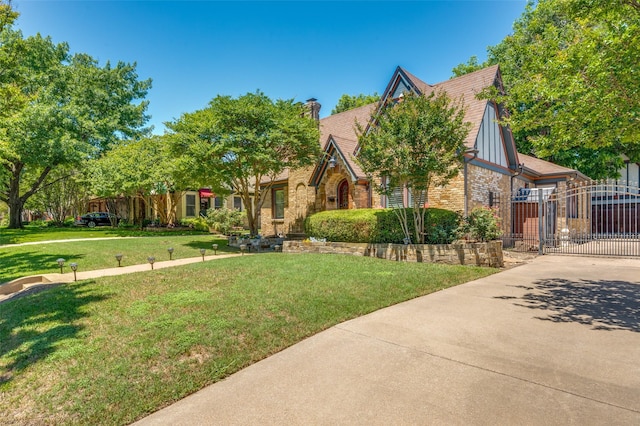 5447 Mccommas Blvd, Dallas, TX 75206 - tudor home with a gate, a chimney, and brick siding