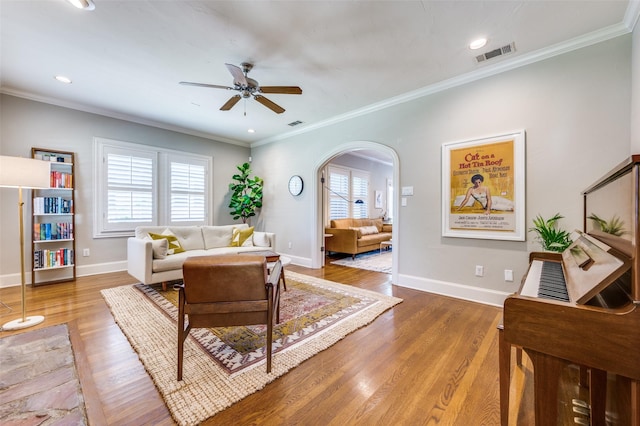 5447 Mccommas Blvd, Dallas, TX 75206 - living room with ceiling fan, arched walkways, wood finished floors, ornamental molding, and baseboards