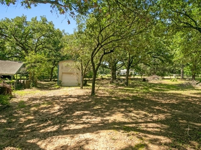 102 Ford Cir, Gun Barrel City, TX 75156 - view of yard featuring a garage and an outbuilding
