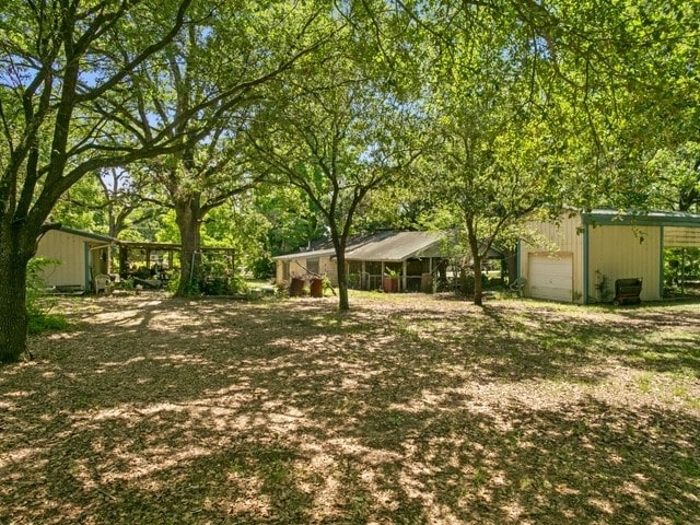 102 Ford Cir, Gun Barrel City, TX 75156 - view of yard with an outbuilding and a garage