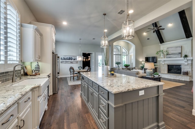 2749 Casa Grande Way, Celina, TX 75009 - kitchen with gray cabinets, arched walkways, ceiling fan, a kitchen island, and freestanding refrigerator