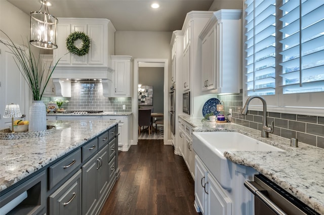 2749 Casa Grande Way, Celina, TX 75009 - kitchen featuring stainless steel appliances, gray cabinets, white cabinetry, a sink, and decorative backsplash