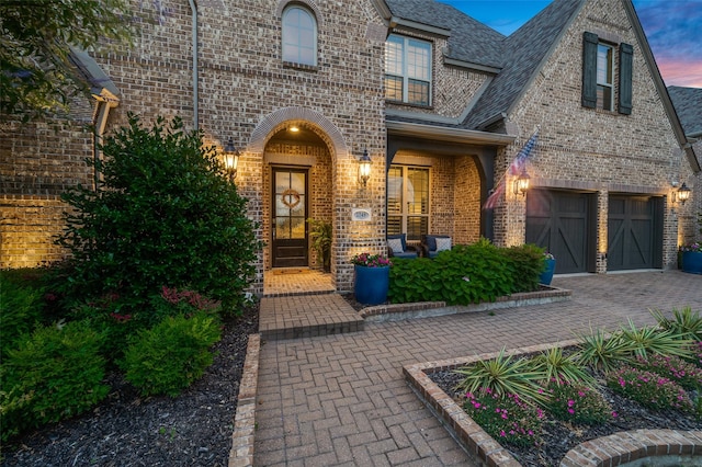 2749 Casa Grande Way, Celina, TX 75009 - doorway to property featuring brick siding, roof with shingles, decorative driveway, and a porch