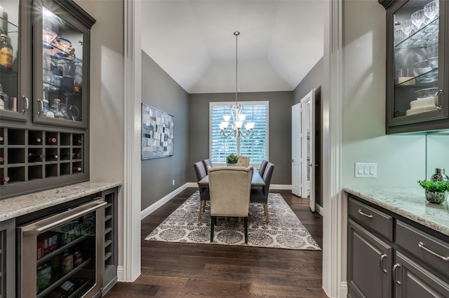 2749 Casa Grande Way, Celina, TX 75009 - dining room with wine cooler, a chandelier, dark wood finished floors, vaulted ceiling, and baseboards