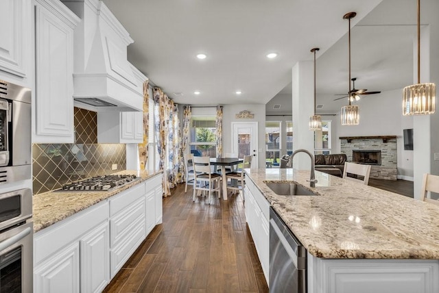 914 Park Vista Dr, Justin, TX 76247 - kitchen with a sink, appliances with stainless steel finishes, a ceiling fan, custom range hood, and dark wood finished floors