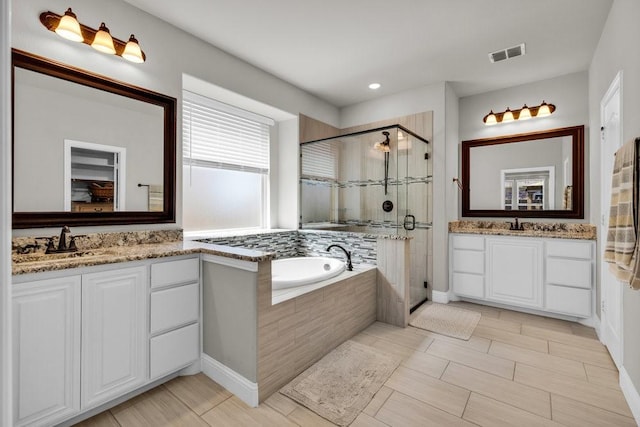 914 Park Vista Dr, Justin, TX 76247 - full bathroom featuring a stall shower, a bath, two vanities, recessed lighting, and baseboards