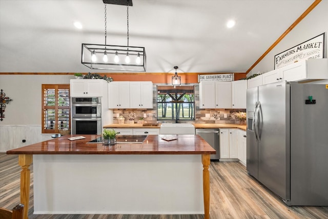 1890 Oak Valley Ln, Corsicana, TX 75110 - kitchen with appliances with stainless steel finishes, wood counters, a sink, white cabinets, and healthy amount of natural light
