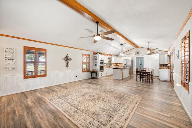 1890 Oak Valley Ln, Corsicana, TX 75110 - living area featuring wainscoting, a ceiling fan, plenty of natural light, wood finished floors, and crown molding
