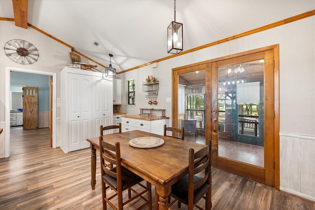 1890 Oak Valley Ln, Corsicana, TX 75110 - dining area featuring lofted ceiling, wood finished floors, a wainscoted wall, and ornamental molding