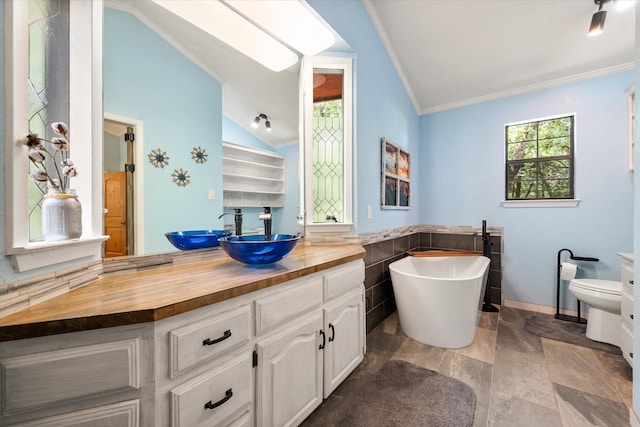 1890 Oak Valley Ln, Corsicana, TX 75110 - full bath with vaulted ceiling, crown molding, toilet, a freestanding tub, and vanity