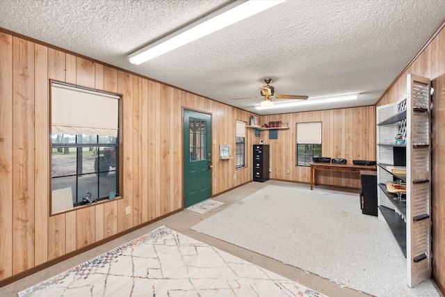 1890 Oak Valley Ln, Corsicana, TX 75110 - kitchen with wooden walls, a textured ceiling, ceiling fan, and baseboards