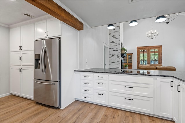 173 Cedar Ridge Dr, China Spring, TX 76633 - kitchen featuring stainless steel fridge with ice dispenser, dark stone countertops, white cabinets, light wood finished floors, and black electric cooktop
