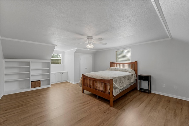 173 Cedar Ridge Dr, China Spring, TX 76633 - bedroom with a textured ceiling, wood finished floors, baseboards, lofted ceiling, and ceiling fan