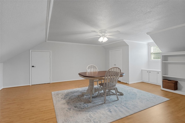 173 Cedar Ridge Dr, China Spring, TX 76633 - dining room featuring a textured ceiling, light wood finished floors, lofted ceiling, ceiling fan, and baseboards