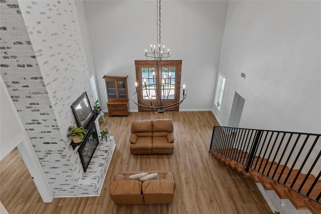 173 Cedar Ridge Dr, China Spring, TX 76633 - living area featuring a high ceiling, wood finished floors, a chandelier, baseboards, and stairway