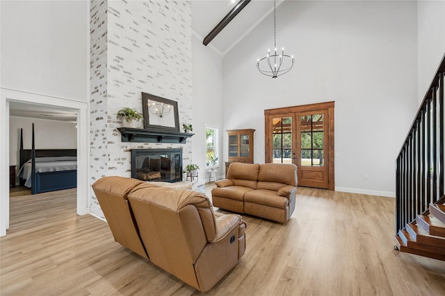 173 Cedar Ridge Dr, China Spring, TX 76633 - living area with high vaulted ceiling, light wood-type flooring, a chandelier, beamed ceiling, and a large fireplace