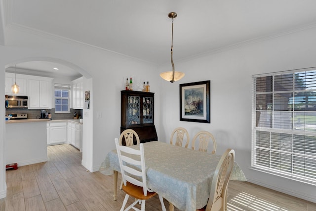 114 Winters Edge Dr, Red Oak, TX 75154 - dining space with arched walkways, light wood finished floors, ornamental molding, and baseboards