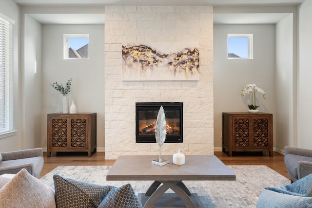 17120 Lacebark Ln, Dallas, TX 75252 - living room with wood finished floors, a stone fireplace, and healthy amount of natural light