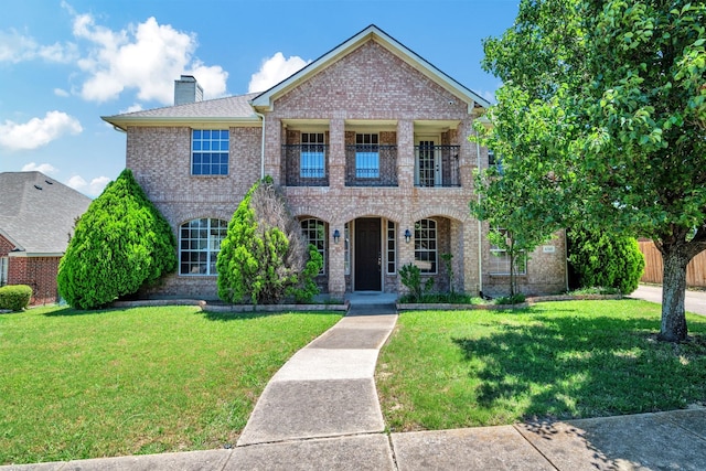 4518 Park Meadow Ct, Garland, TX 75043 - view of front of home with a balcony, brick siding, a chimney, and a porch