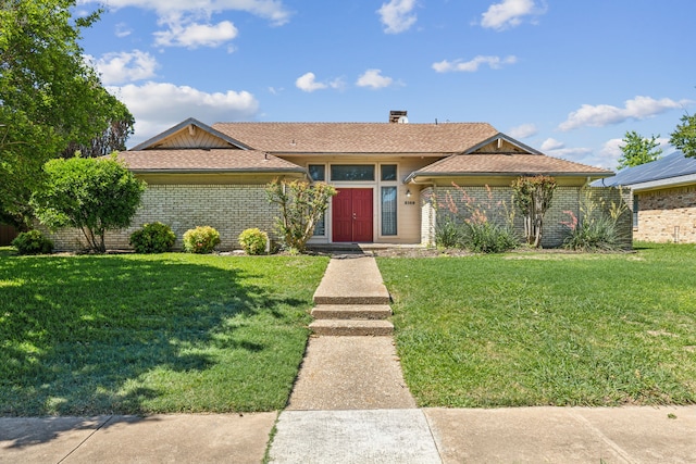 3109 Bullock Dr, Plano, TX 75023 - view of front of property with a front yard, brick siding, and a chimney