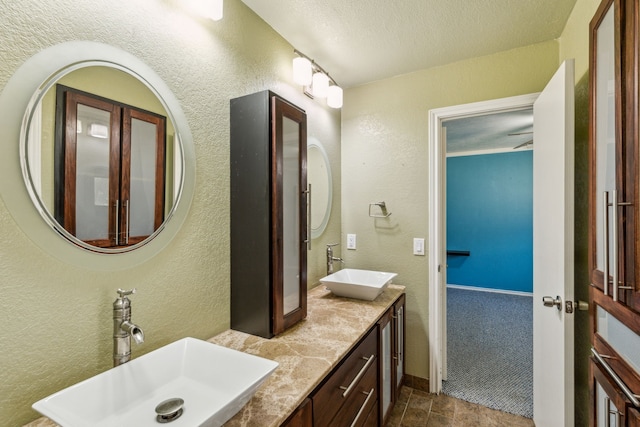 3109 Bullock Dr, Plano, TX 75023 - full bath featuring a textured wall, double vanity, and a textured ceiling