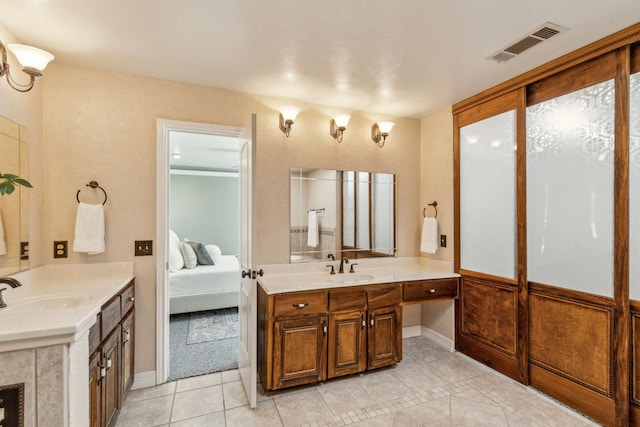 3109 Bullock Dr, Plano, TX 75023 - ensuite bathroom featuring tile patterned flooring, two vanities, and baseboards