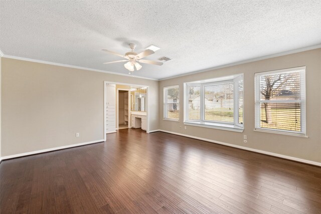 4201 Westchester Dr, Waco, TX 76710 - spare room featuring ceiling fan, a textured ceiling, plenty of natural light, dark wood-type flooring, and baseboards