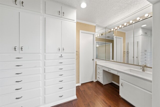 4201 Westchester Dr, Waco, TX 76710 - bathroom with a textured ceiling, wood finished floors, crown molding, and vanity