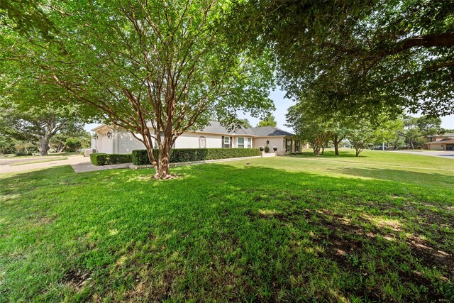 4201 Westchester Dr, Waco, TX 76710 - ranch-style home featuring a front yard, an attached garage, and driveway