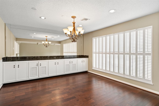 4201 Westchester Dr, Waco, TX 76710 - kitchen featuring a chandelier, dark countertops, dark wood-style flooring, a textured ceiling, and pendant lighting