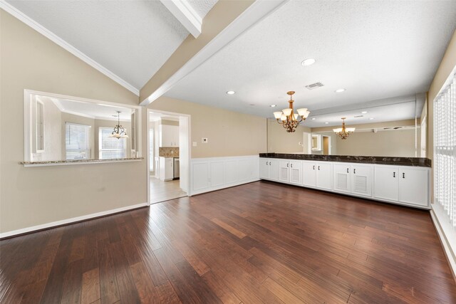 4201 Westchester Dr, Waco, TX 76710 - unfurnished living room with a chandelier, dark wood-type flooring, wainscoting, recessed lighting, and lofted ceiling