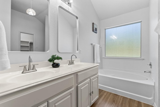 1132 Singletree Dr, Forney, TX 75126 - full bath with vaulted ceiling, wood finished floors, double vanity, and a bathtub