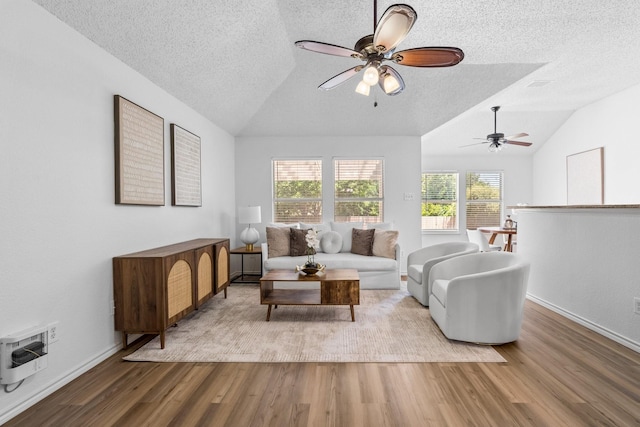 1132 Singletree Dr, Forney, TX 75126 - living area featuring lofted ceiling, a textured ceiling, wood finished floors, a ceiling fan, and heating unit