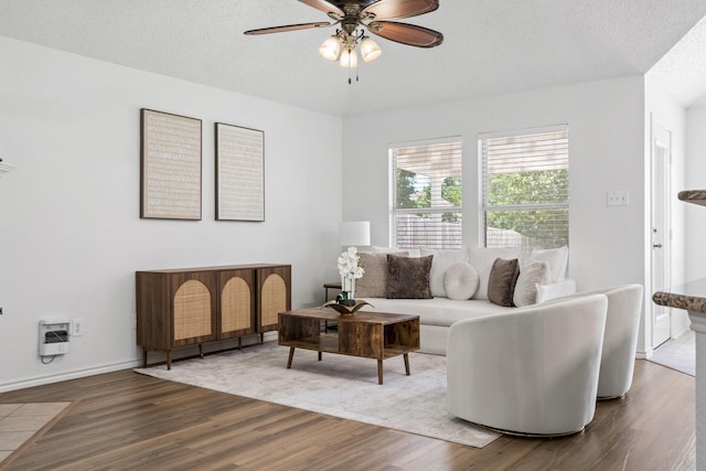 1132 Singletree Dr, Forney, TX 75126 - living room with wood finished floors, ceiling fan, a textured ceiling, and baseboards