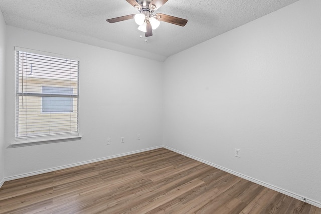 1132 Singletree Dr, Forney, TX 75126 - unfurnished room featuring wood finished floors, baseboards, ceiling fan, a textured ceiling, and plenty of natural light