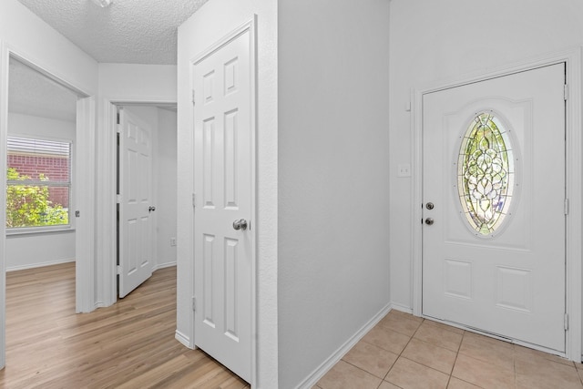 1132 Singletree Dr, Forney, TX 75126 - foyer featuring baseboards, a textured ceiling, and light tile patterned flooring