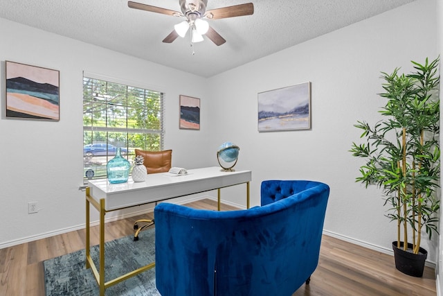1132 Singletree Dr, Forney, TX 75126 - home office with wood finished floors, baseboards, ceiling fan, and a textured ceiling