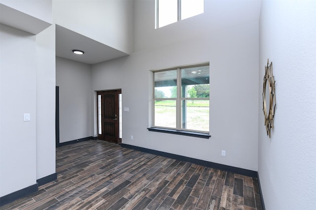 8600 Lakeview Dr, Cleburne, TX 76033 - spare room featuring a high ceiling, dark wood-style floors, and baseboards