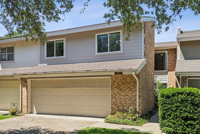 2902 Shady Lake Cir, Carrollton, TX 75006 - view of front of home with a garage, brick siding, and roof with shingles