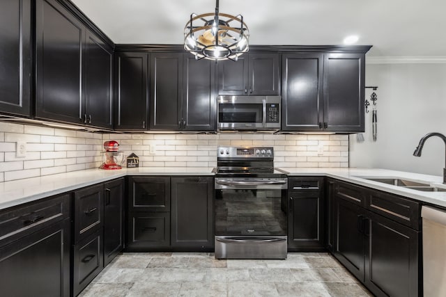 2902 Shady Lake Cir, Carrollton, TX 75006 - kitchen with stainless steel appliances, dark cabinetry, backsplash, crown molding, and hanging light fixtures