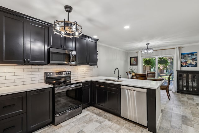 2902 Shady Lake Cir, Carrollton, TX 75006 - kitchen featuring a chandelier, stainless steel appliances, tasteful backsplash, ornamental molding, and dark cabinets