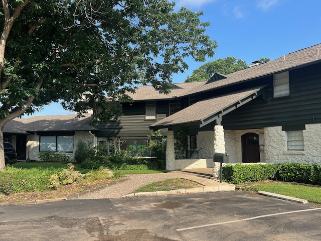 2902 Shady Lake Cir, Carrollton, TX 75006 - view of front of property featuring stone siding, uncovered parking, and roof with shingles