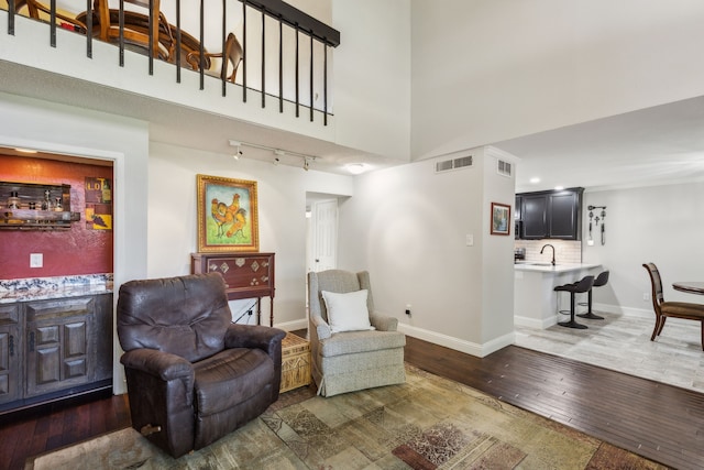 2902 Shady Lake Cir, Carrollton, TX 75006 - sitting room with hardwood / wood-style flooring, baseboards, rail lighting, and a high ceiling