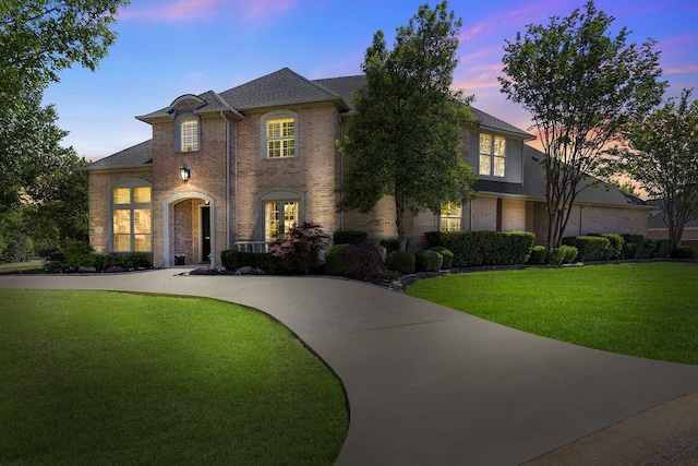 7513 Sugarbush Dr, Garland, TX 75044 - french country inspired facade featuring a lawn, brick siding, and a shingled roof