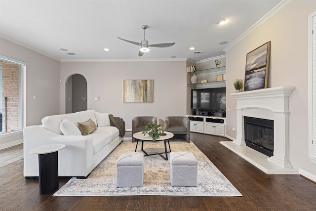 7513 Sugarbush Dr, Garland, TX 75044 - living room featuring arched walkways, ceiling fan, recessed lighting, dark wood-style flooring, and a glass covered fireplace