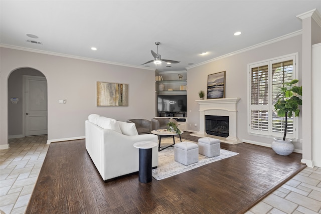 7513 Sugarbush Dr, Garland, TX 75044 - living area with arched walkways, baseboards, a ceiling fan, ornamental molding, and a fireplace with raised hearth
