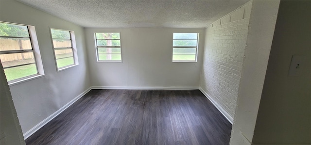 6216 Maurie Dr, Watauga, TX 76148 - empty room featuring a textured ceiling, baseboards, dark wood-style flooring, and vaulted ceiling
