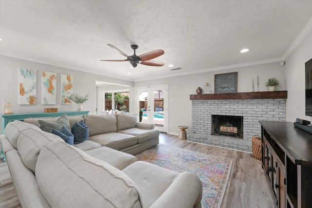 12212 Ridgefair Pl, Farmers Branch, TX 75234 - living room with ceiling fan, wood finished floors, recessed lighting, a brick fireplace, and ornamental molding