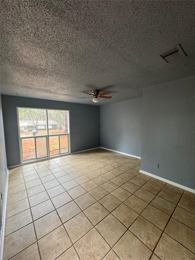 825 Willow Dr, Shreveport, LA 71118 - empty room with ceiling fan, light tile patterned flooring, a textured ceiling, and baseboards