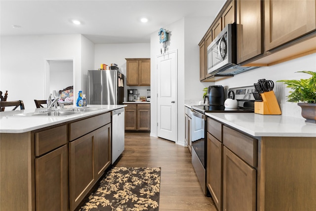 516 Wrangler Dr, Josephine, TX 75189 - kitchen with appliances with stainless steel finishes, a sink, dark wood-style floors, light countertops, and recessed lighting